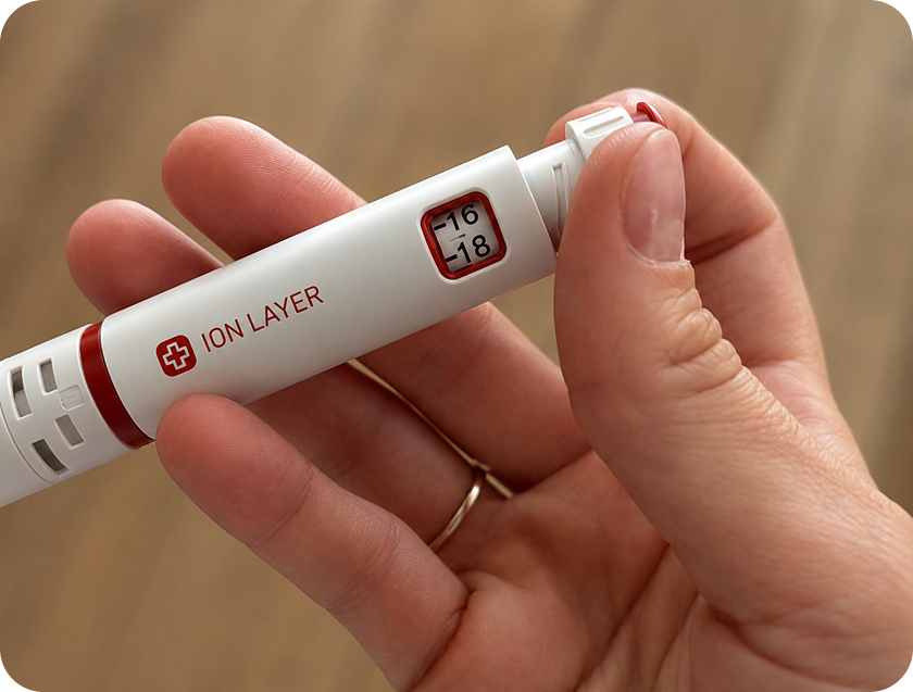 A hand holding the Ion Layer NAD+ injector pen
